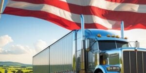 Independence Day image with truck on the road under the flag.