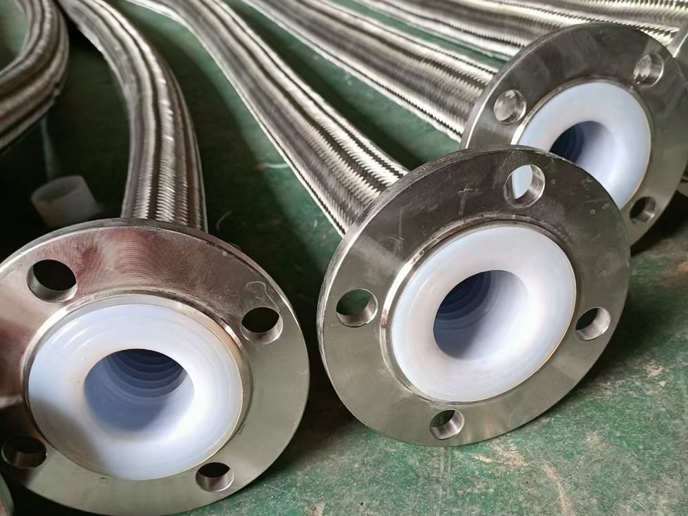 PTFE-lined stainless steel braided flex hoses with flanged ends for chemical and high-temperature fluid transfer. image from sunnysteel.com